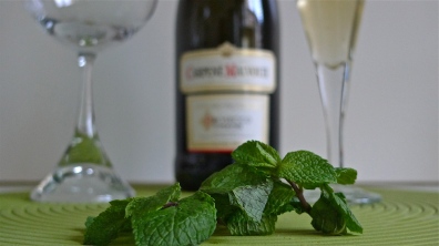 Elderflower syrup, Prosecco and a glass behind fresh mint leaves | ©Tom Palladio Images