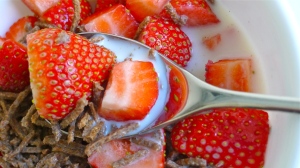 Strawberries over breakfast cereal | ©Tom Palladio Images
